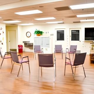 A well-lit meeting room with chairs arranged in a circle.