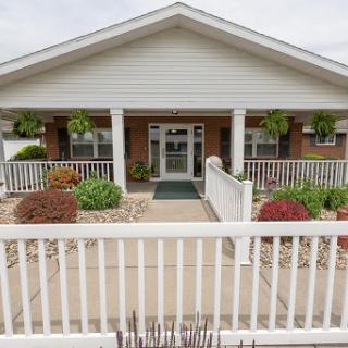 Welcoming front entrance of a residential building with landscaped garden.