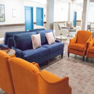 A vibrant lounge area featuring blue and orange seating arrangements.