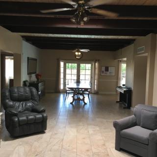 Spacious living room with comfortable seating and a dining area.