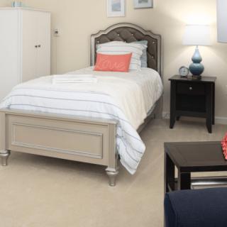 A cozy bedroom with a single bed and modern decor.