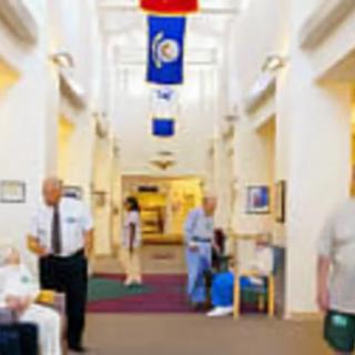 A busy hospital hallway with staff and patients.