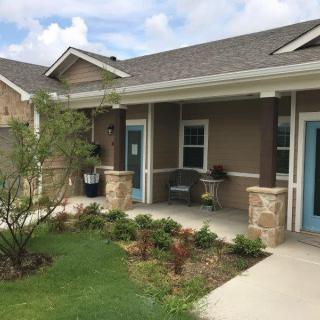 A charming residential house with a small garden and a welcoming porch.