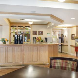 A welcoming hotel lobby with a wooden reception desk and warm lighting.