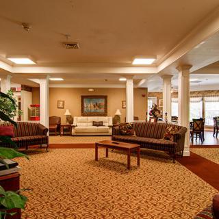 A spacious and warmly lit hotel lobby with comfortable seating.