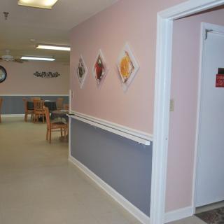 A hallway with wall art and seating area.