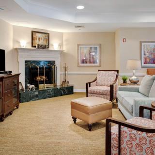 A cozy living room with comfortable seating and a fireplace.