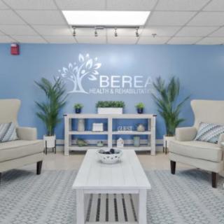 A cozy waiting area with comfortable seating, plants, and a soothing blue wall.