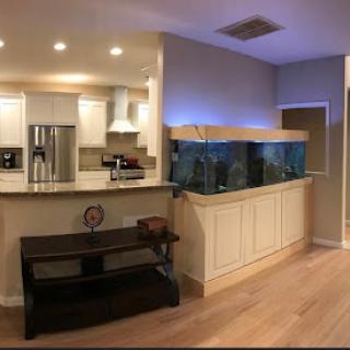 A modern living space featuring a stylish aquarium integrated into the cabinetry.