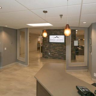 A modern office lobby with a reception desk and elegant lighting.