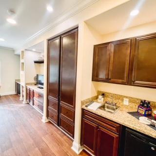 A modern kitchen with wooden cabinets and hardwood flooring.