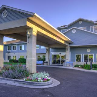 A welcoming hotel entrance surrounded by landscaped gardens.