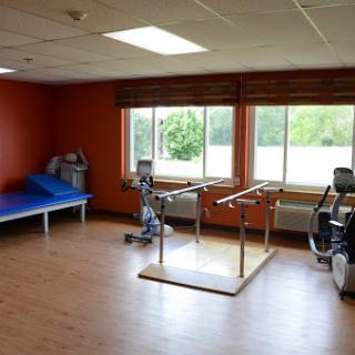 A well-equipped physical therapy room designed for rehabilitation and exercise.