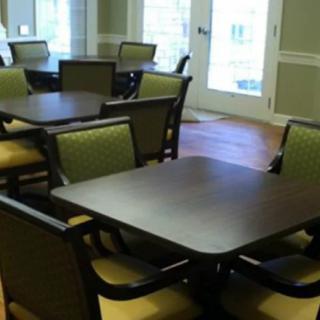 An empty dining area with multiple tables and chairs arranged neatly.