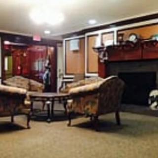 A cozy lounge with comfortable seating around a fireplace.