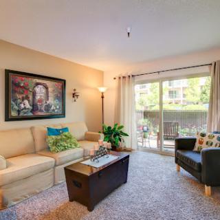 A cozy and inviting living room featuring modern furniture and ample natural light.