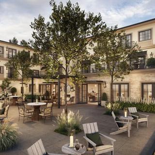 A beautifully designed courtyard with comfortable seating and lush greenery.