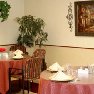A cozy dining area with neatly set tables and warm decor.