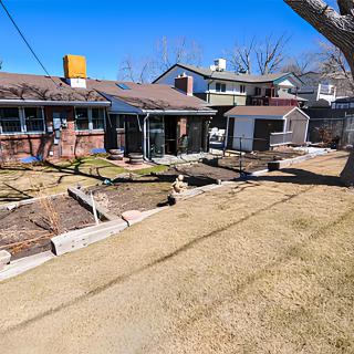 A view of a residential backyard with multiple houses and landscaped areas.