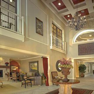 Elegant lobby with stylish decor and a grand chandelier.