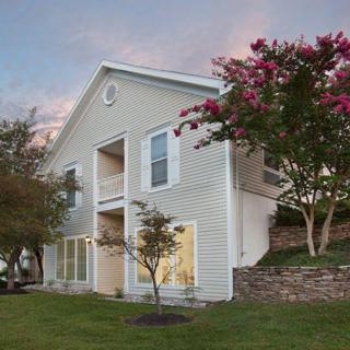 Two-story house with a garden at sunset.