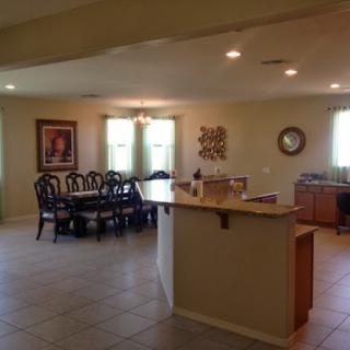 A spacious open-concept kitchen and dining area, featuring modern furnishings and ample natural light.