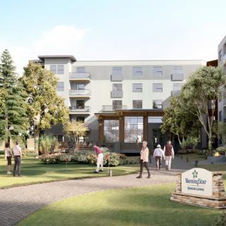 A modern residential building with people walking in the landscaped garden.