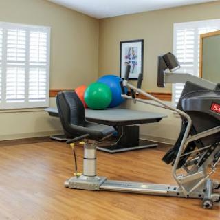 A well-equipped exercise space featuring fitness equipment and colorful exercise balls.