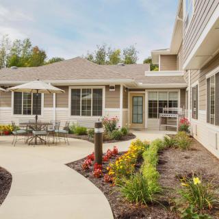 A well-maintained residential patio with outdoor seating and landscaped garden.