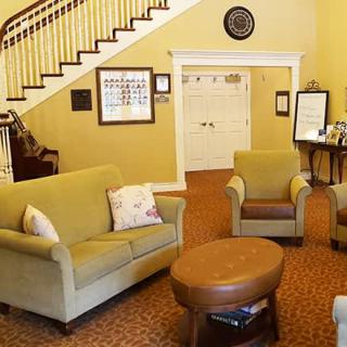 A cozy living room with comfortable seating and a staircase leading upstairs.