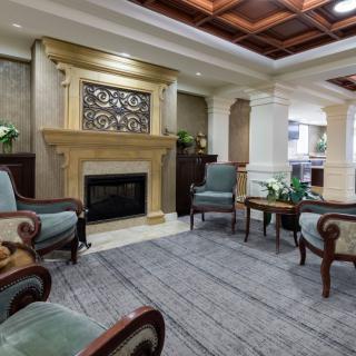 A traditional living room with a fireplace and elegant seating arrangement.