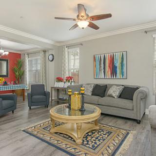 A stylish and modern living room featuring a comfortable sofa, artistic wall decor, and vibrant accents.