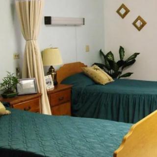 A cozy bedroom with twin beds and elegant decor.
