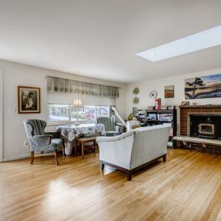 A cozy living room with elegant furniture and a skylight.