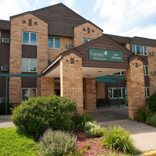 Front view of a residential building with landscaped entrance.
