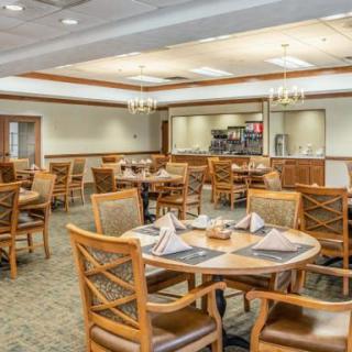 A neatly arranged dining area with tables set for guests.