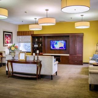 A modern living room with comfortable seating and a TV.