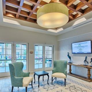 A cozy living room with stylish furniture and a modern chandelier.