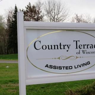 A sign for Country Terrace of Wisconsin Assisted Living, located in an outdoor setting.