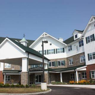 A modern residential building with multiple stories, possibly a senior living or retirement home.