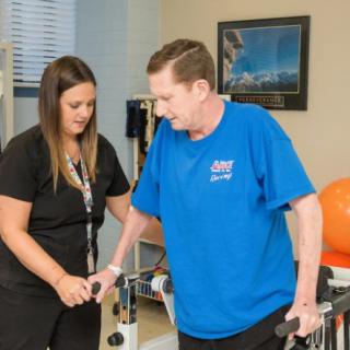 A therapist assists a patient during a physical rehabilitation session.