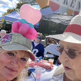 Enjoying a lively outdoor event with festive hats and colorful balloons!