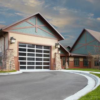 A modern residential garage with a stylish exterior and a curved driveway.