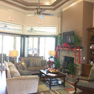 A cozy living room with a fireplace, decorated for the holidays.