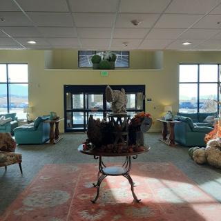 A spacious and inviting lobby featuring comfortable seating, elegant decor, and plenty of natural light.