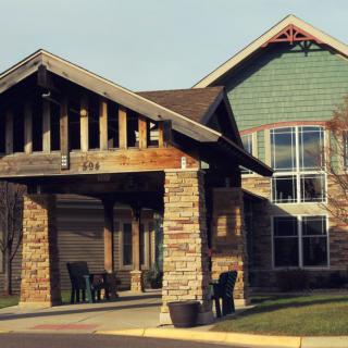 A residential building with a stone and wood entrance.