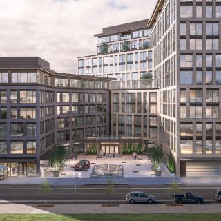 A contemporary office building complex with a spacious courtyard in an urban setting.