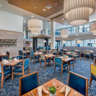 A modern restaurant dining area with stylish furniture and elegant lighting.