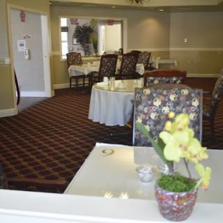 A cozy lounge area featuring comfortable seating and decorative flowers.