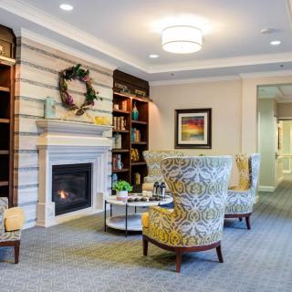 A cozy living room with a fireplace and comfortable seating.